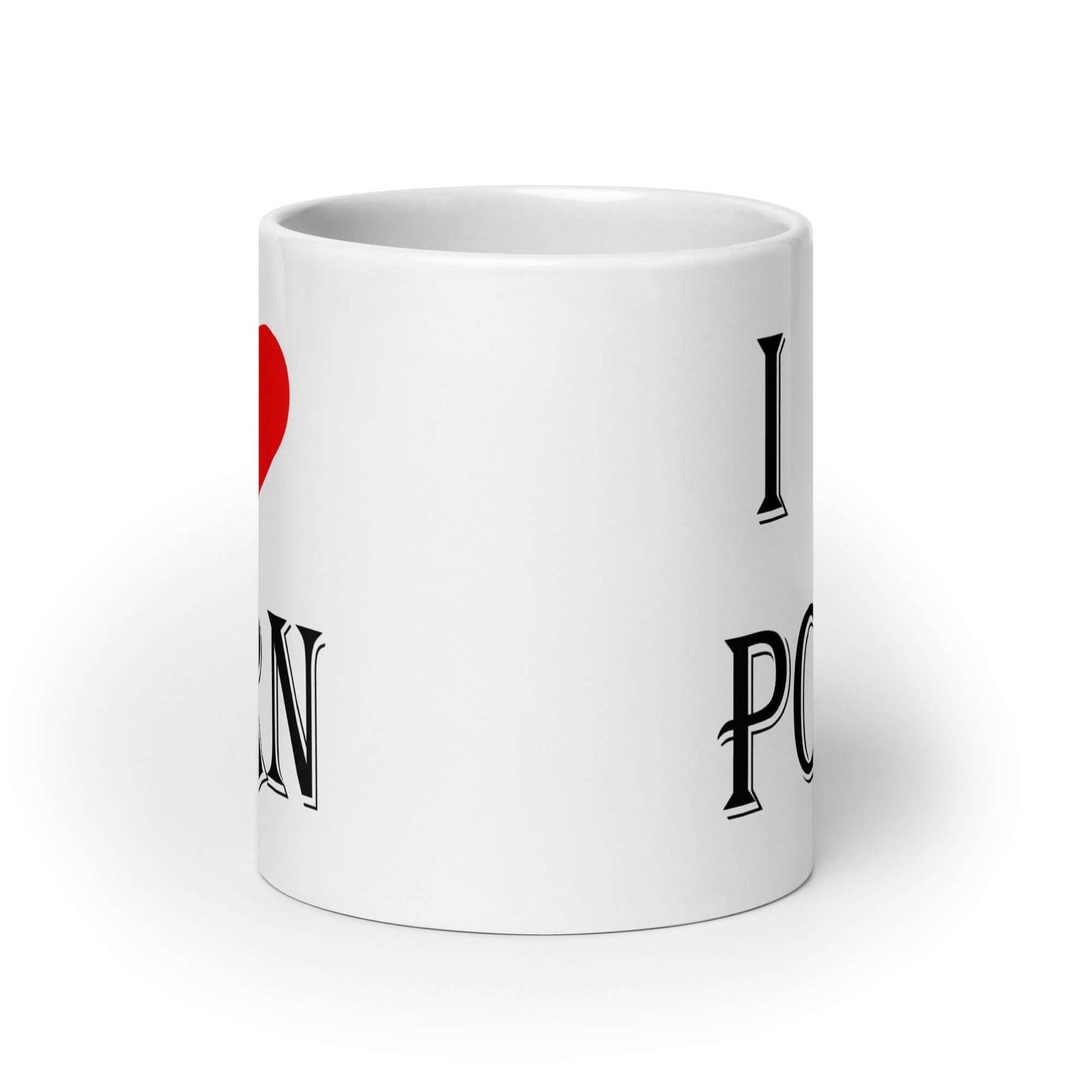 White ceramic coffee mug with the phrase I heart porn printed on both sides of the mug. The heart is red.