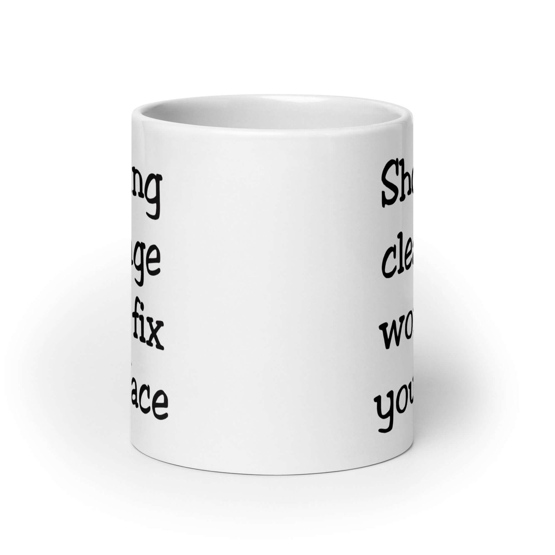 White ceramic mug with the phrase Showing cleavage won't fix your face printed on both sides.