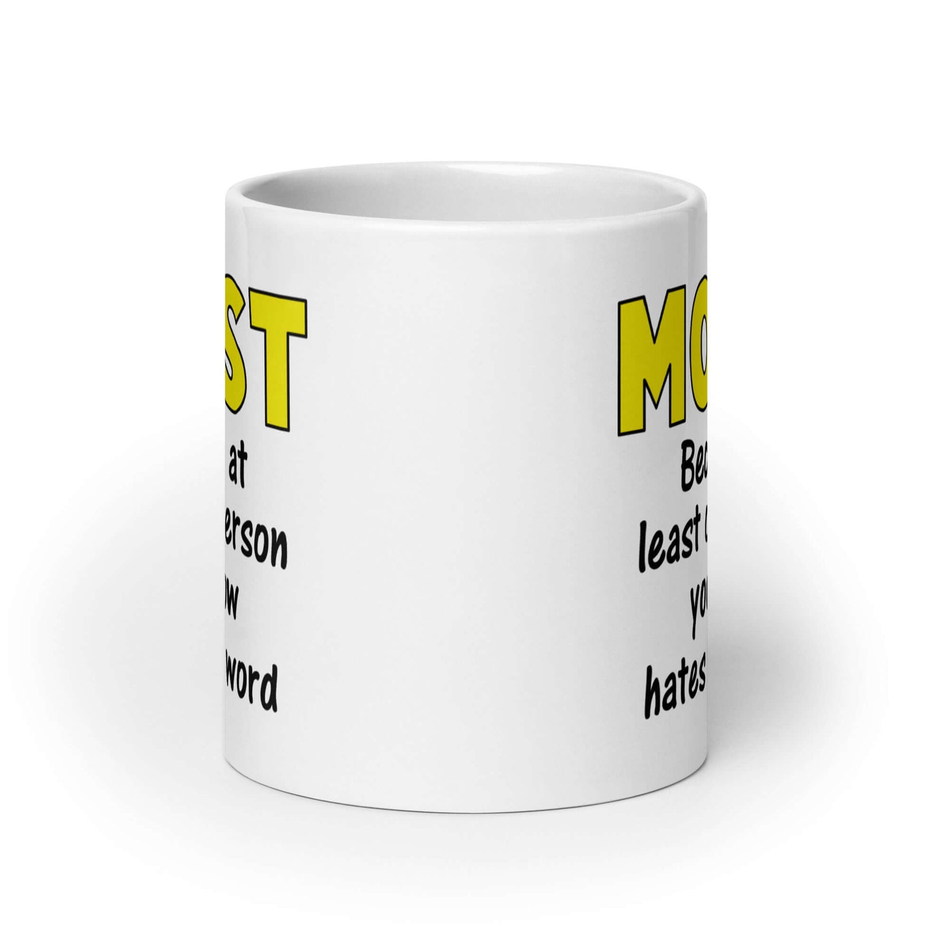 White ceramic coffee mug with the word Moist printed in large yellow bold font. In smaller font under the word moist is the phrase Because at least one person you know hates this word. The text is printed on both sides of the mug.