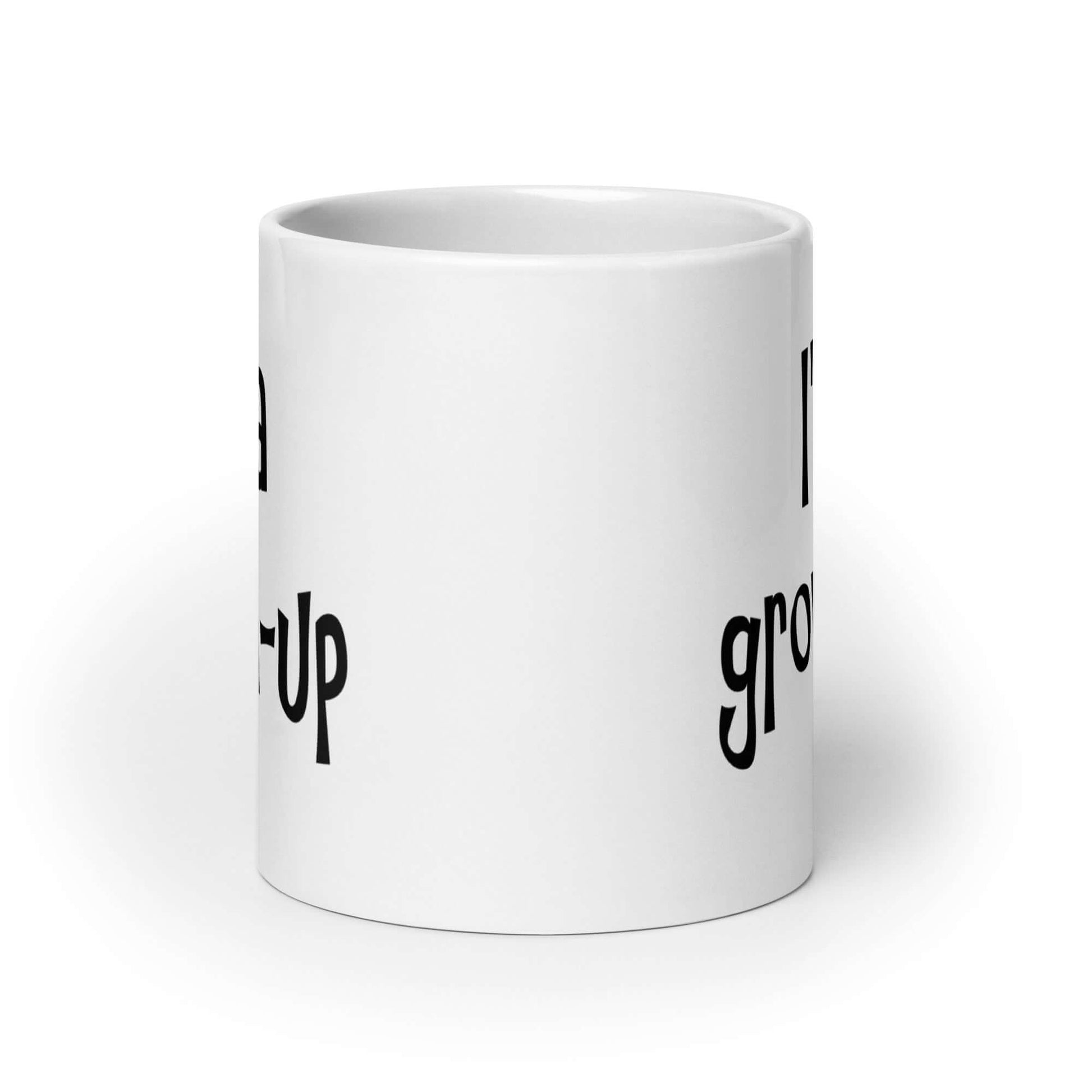 White ceramic coffee mug with the words I'm a grown-up printed on both sides of the mug.