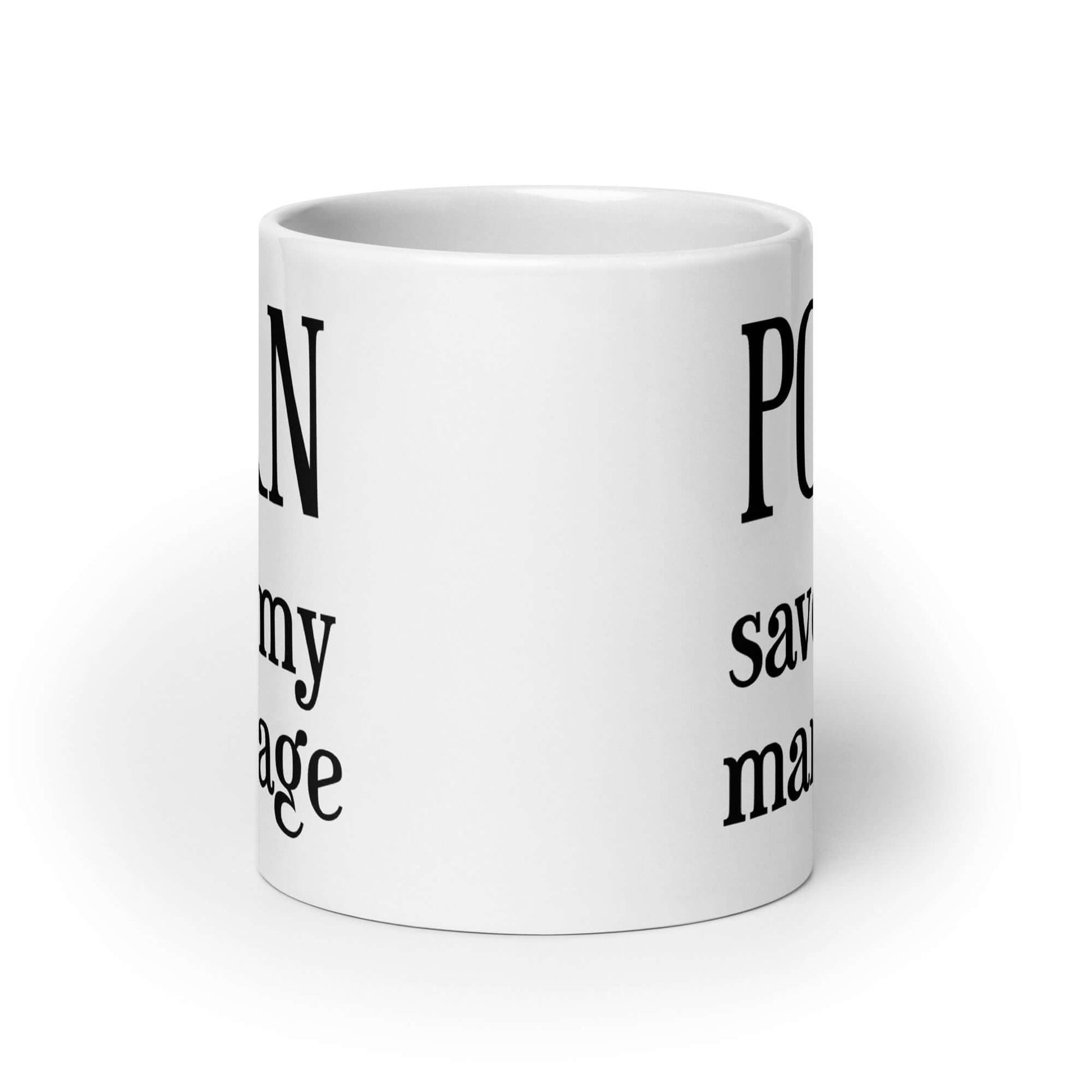 White ceramic mug with the phrase Porn saved my marriage printed on both sides of the mug.