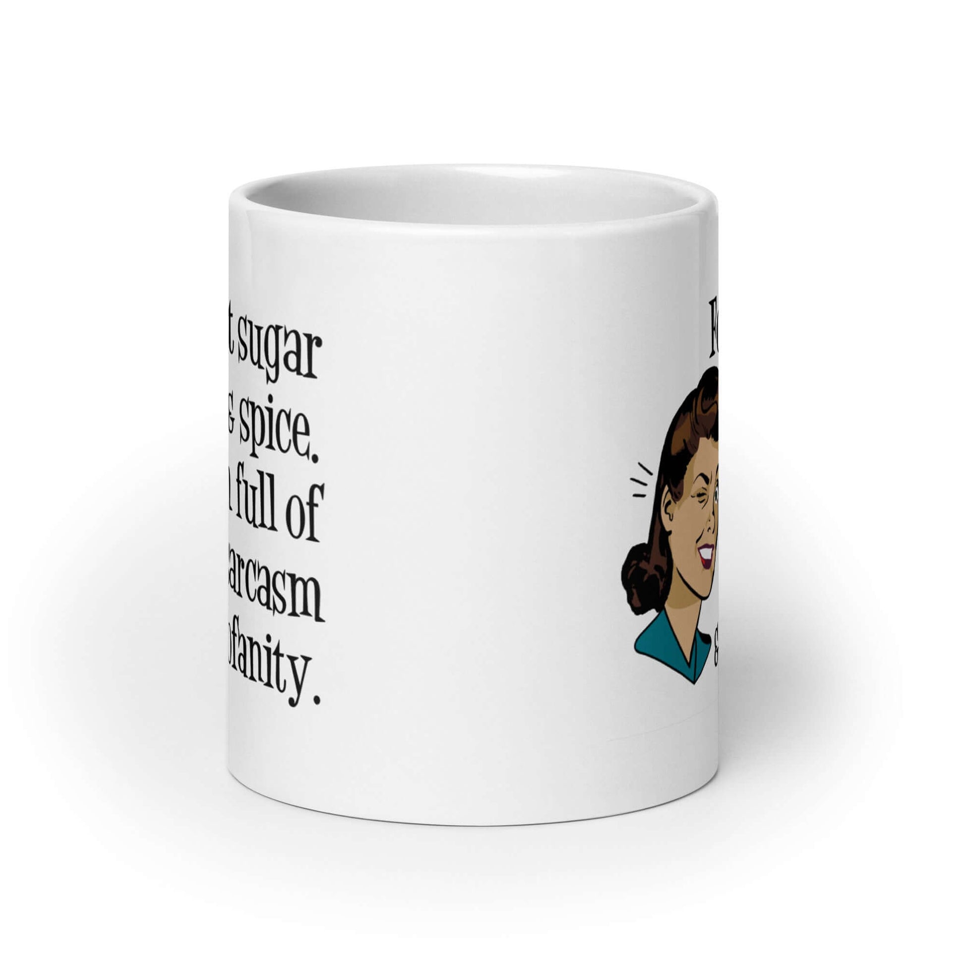 White ceramic coffee mug with image of winking retro woman and the words Forget sugar and spice, I'm full of sarcasm and profanity.