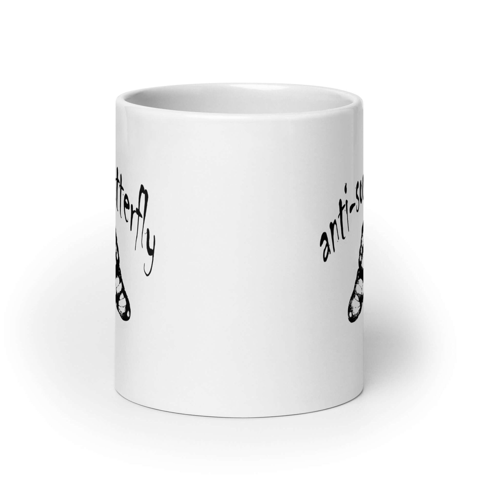 White ceramic coffee mug with an image of an upside down butterfly and the words Anti-social butterfly printed on both sides of the mug.