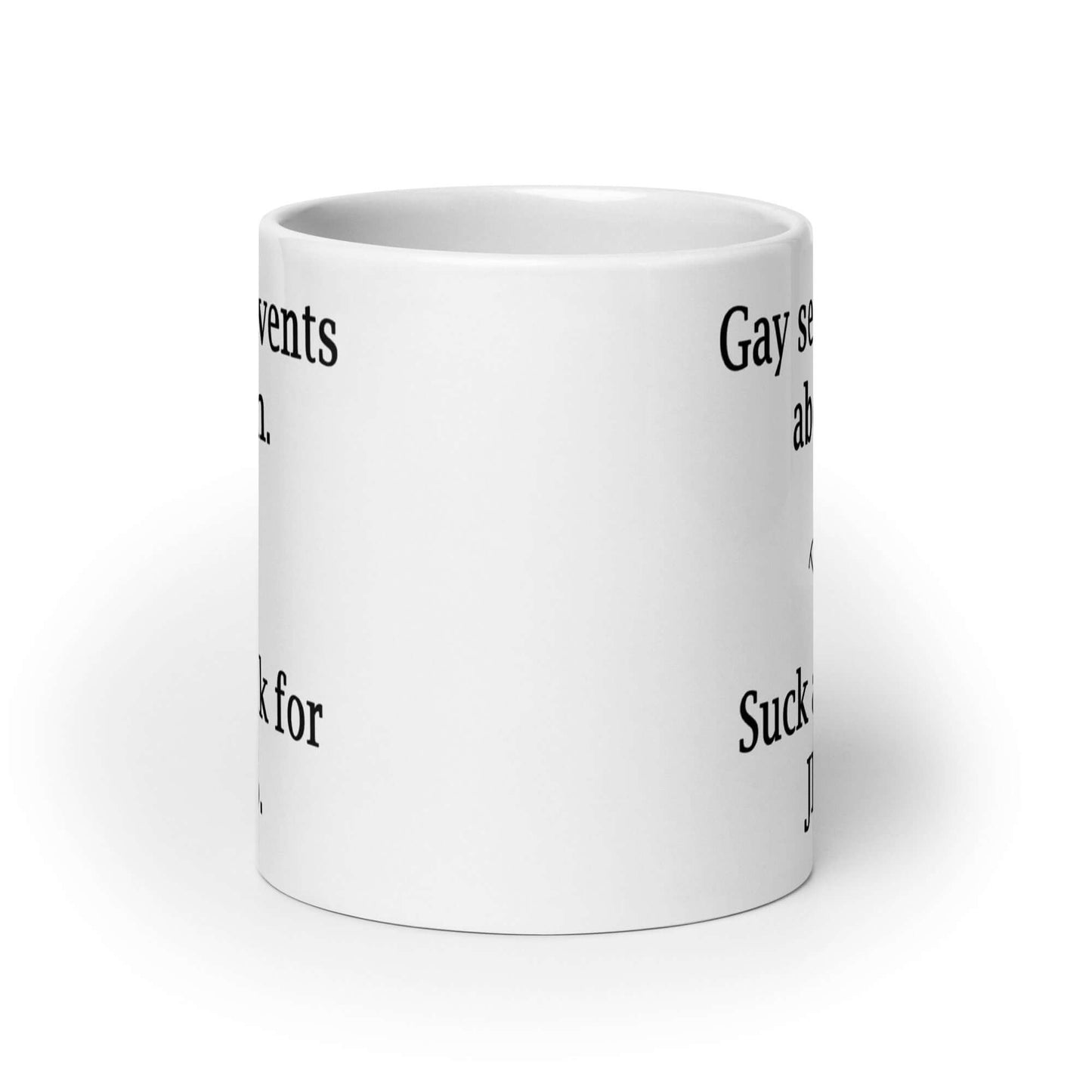 White ceramic coffee mug with the phrase Gay sex prevents abortion. Suck a cock for Jesus printed on both sides of the mug.