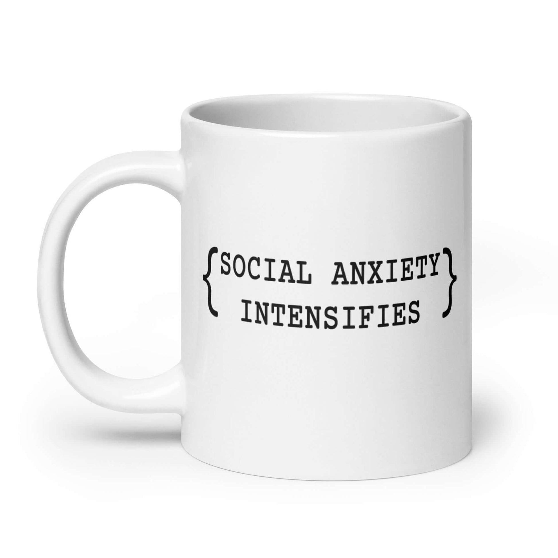 White ceramic coffee mug with the words Social anxiety intensifies printed on both sides.