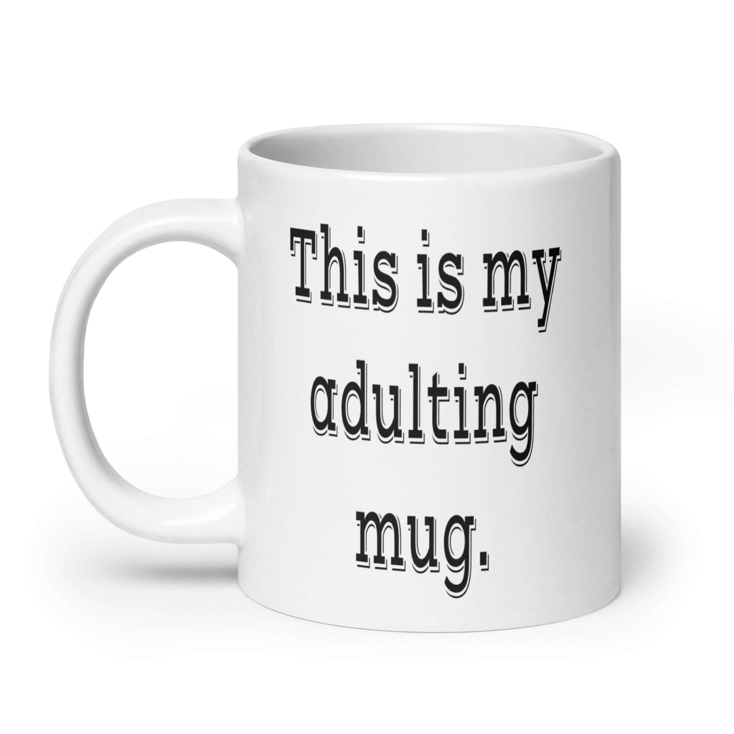 White ceramic coffee mug with the phrase This is my adulting mug printed on both sides of the mug.