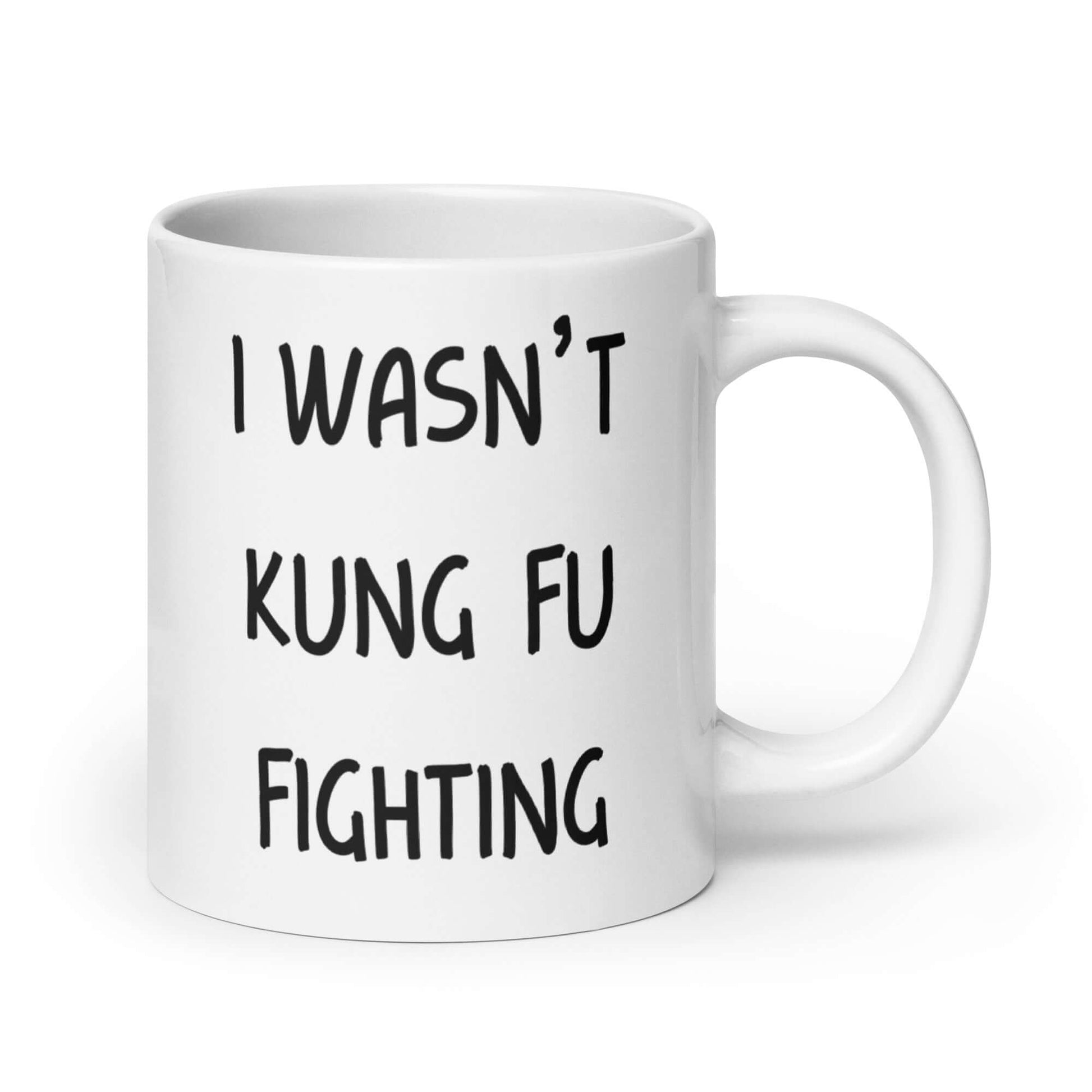 White ceramic coffee mug with the funny phrase I wasn't kung fu fighting printed on both sides.