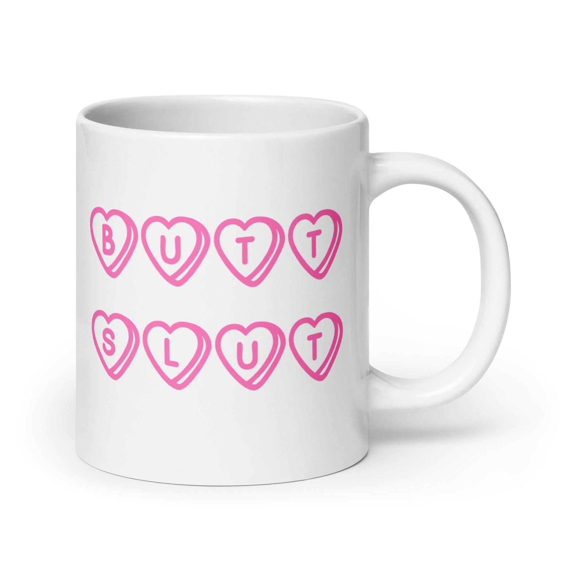 White ceramic mug with the words Butt Slut printed in pink on both sides. Pink hearts are around each letter in the text.