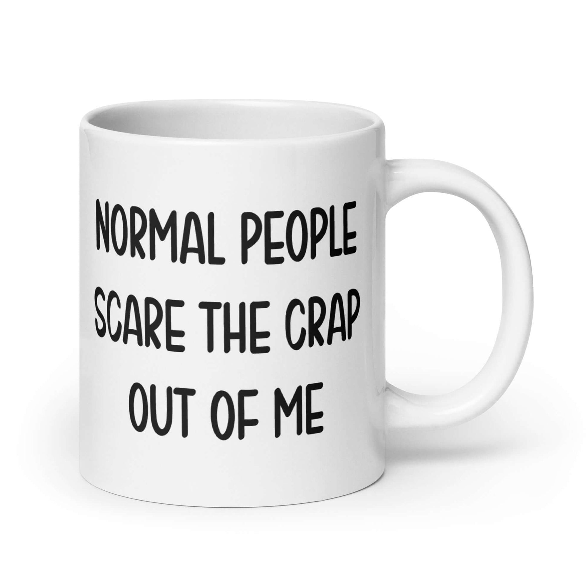 White ceramic coffee mug with the phrase Normal people scare the crap out of me printed on both sides.