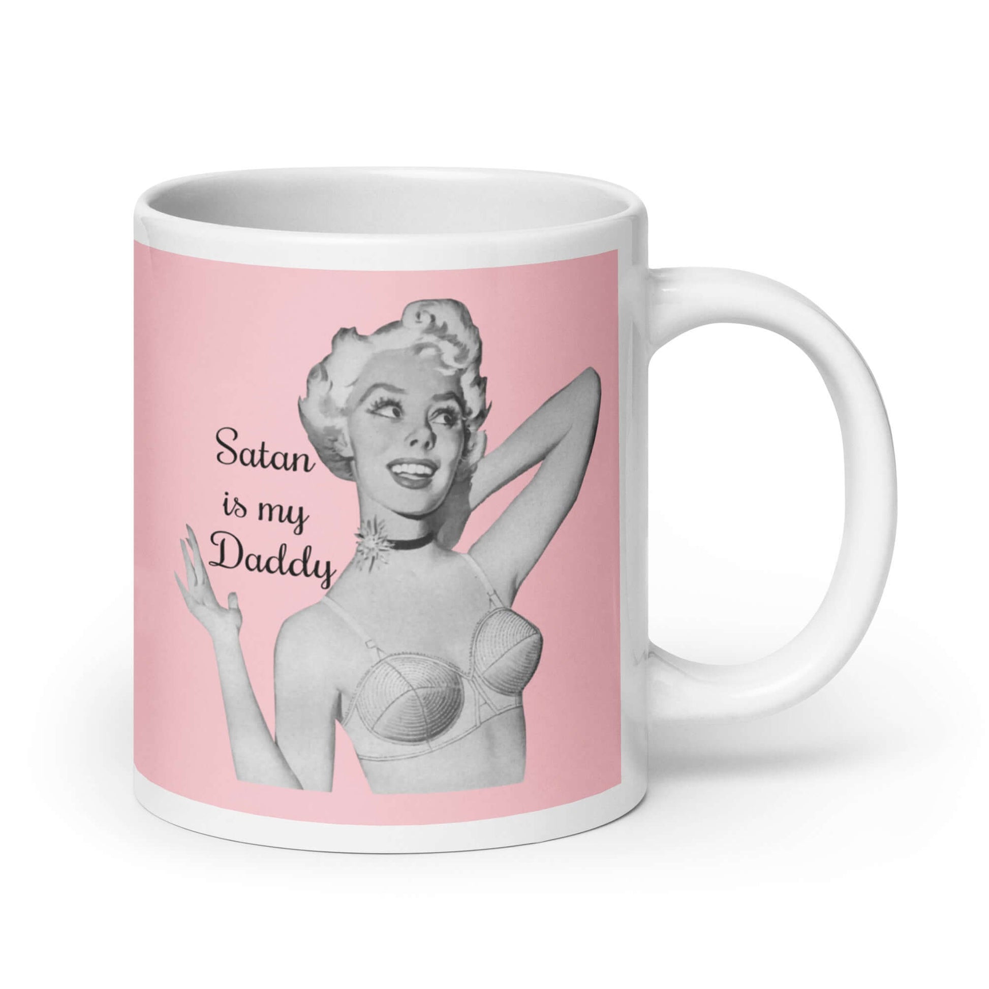 Pink and white ceramic coffee mug with an image of a retro black & white pin-up model and the phrase Satan is my Daddy printed on both sides.