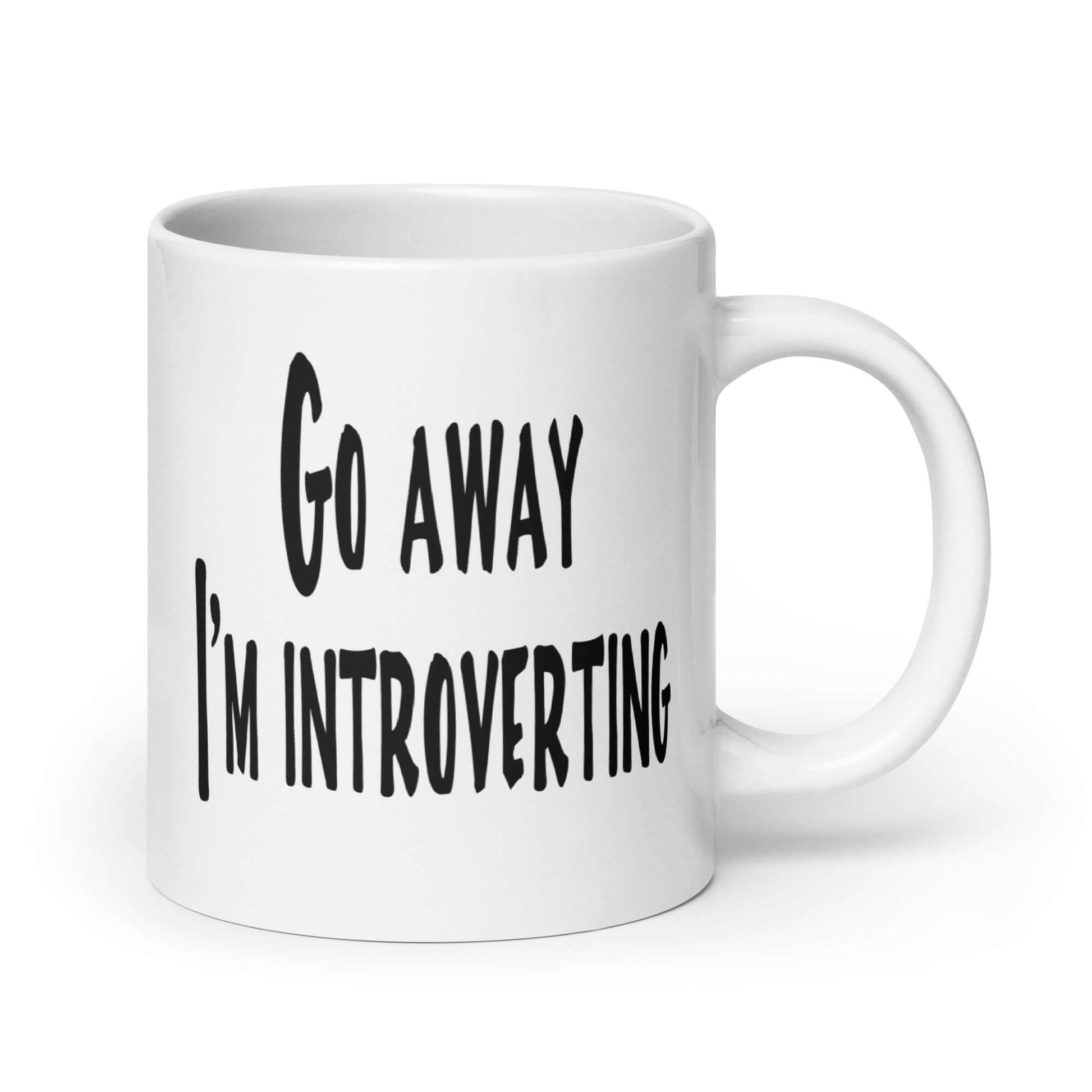 White ceramic coffee mug with the phrase Go away, I'm introverting printed on both sides of the mug.