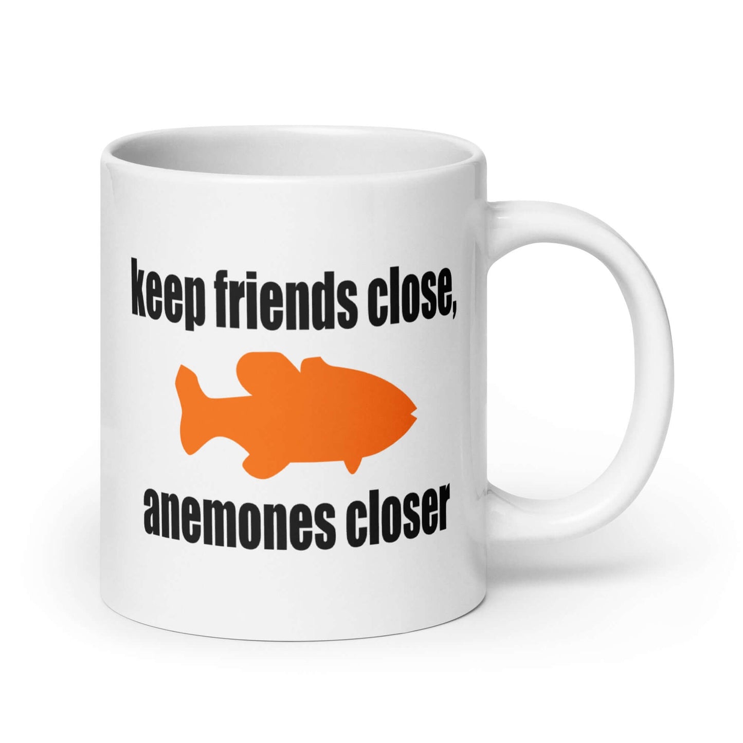 White ceramic coffee mug with the pun phrase Keep friends close, anemones closer with an image of an orange fish printed on both sides of the mug.