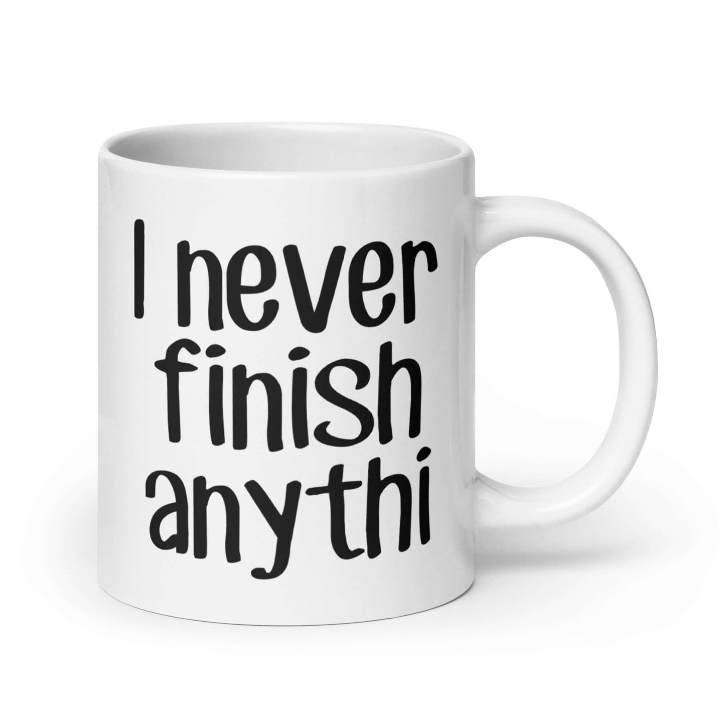 White ceramic coffee mug with the phrase I never finish anything printed on both sides. The letters n and g are missing from the word anything.