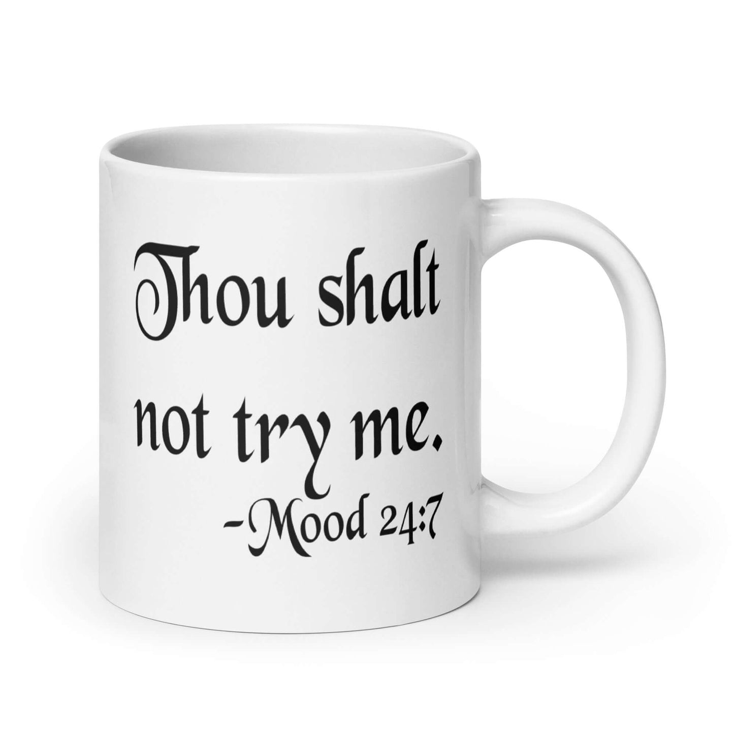 White ceramic coffee mug with the mock scripture quote Thou shalt not try me Mood 24:7 printed on both sides of the mug.