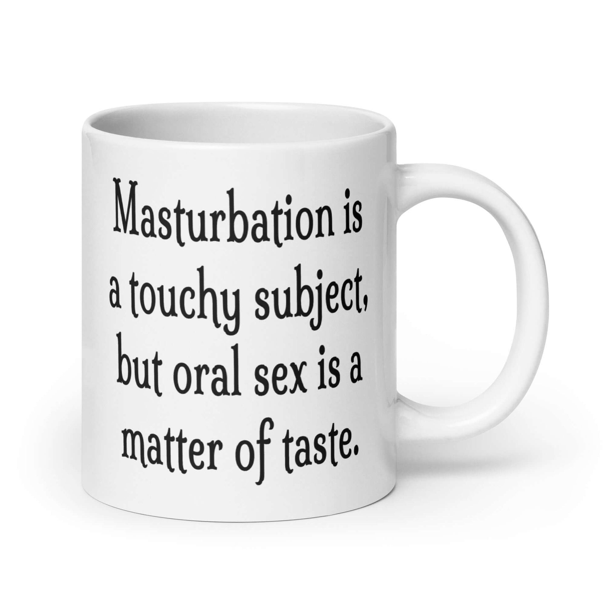 White ceramic coffee mug with the suggestive phrase Masturbation is a touchy subject, but oral sex is a matter of taste printed on both sides of the mug.