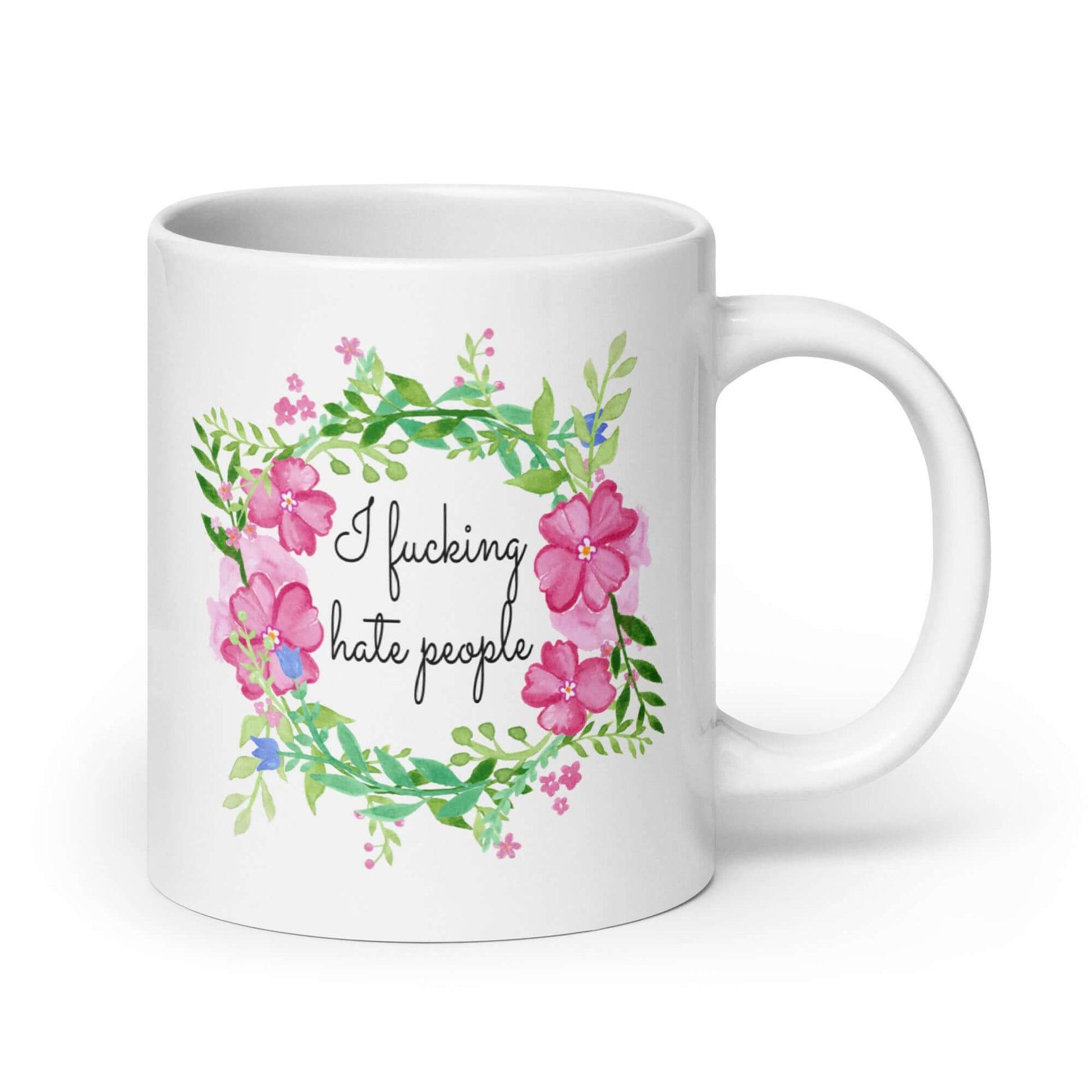 White ceramic mug with pink and green floral wreath image and the words I fucking hate people printed on both sides.