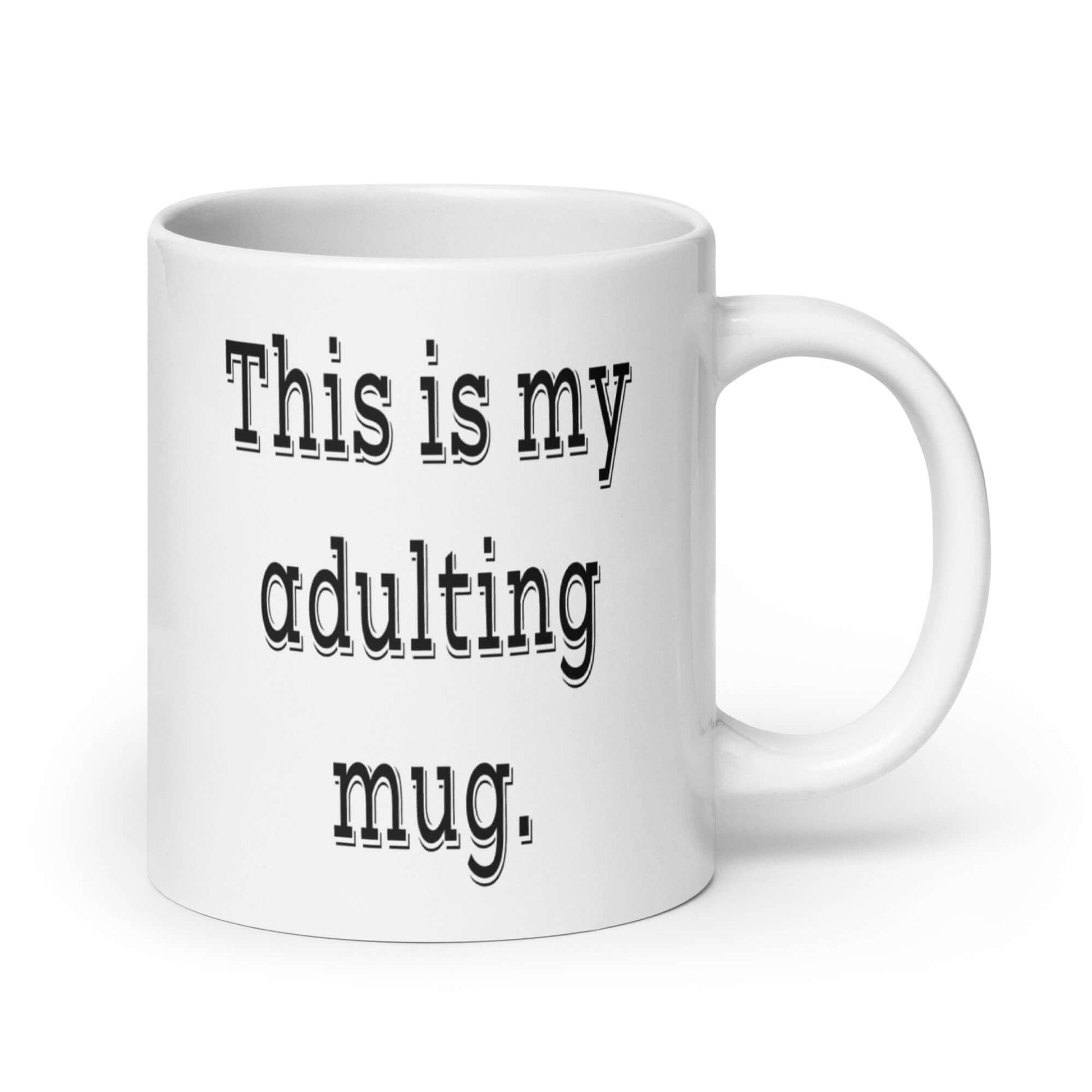 White ceramic coffee mug with the phrase This is my adulting mug printed on both sides of the mug.