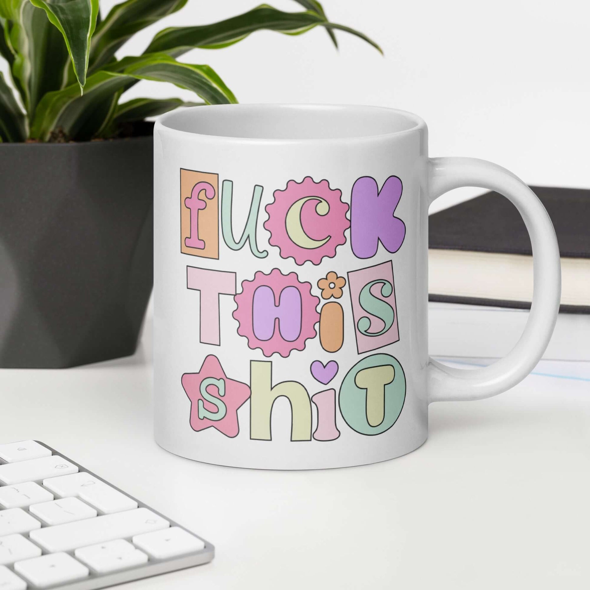 White ceramic coffee mug with colorful pastel font Fuck this shit graphics printed on both sides.