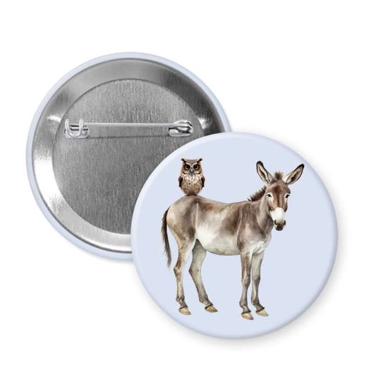 Button badge with a donkey and owl design on a white background