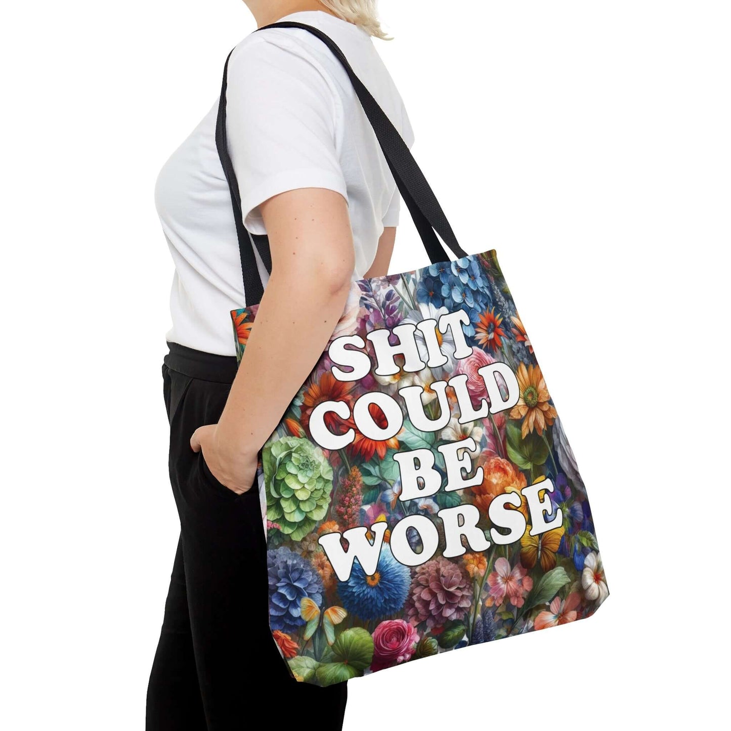 Tote bag with floral background and the words Shit could be worse printed on both sides.