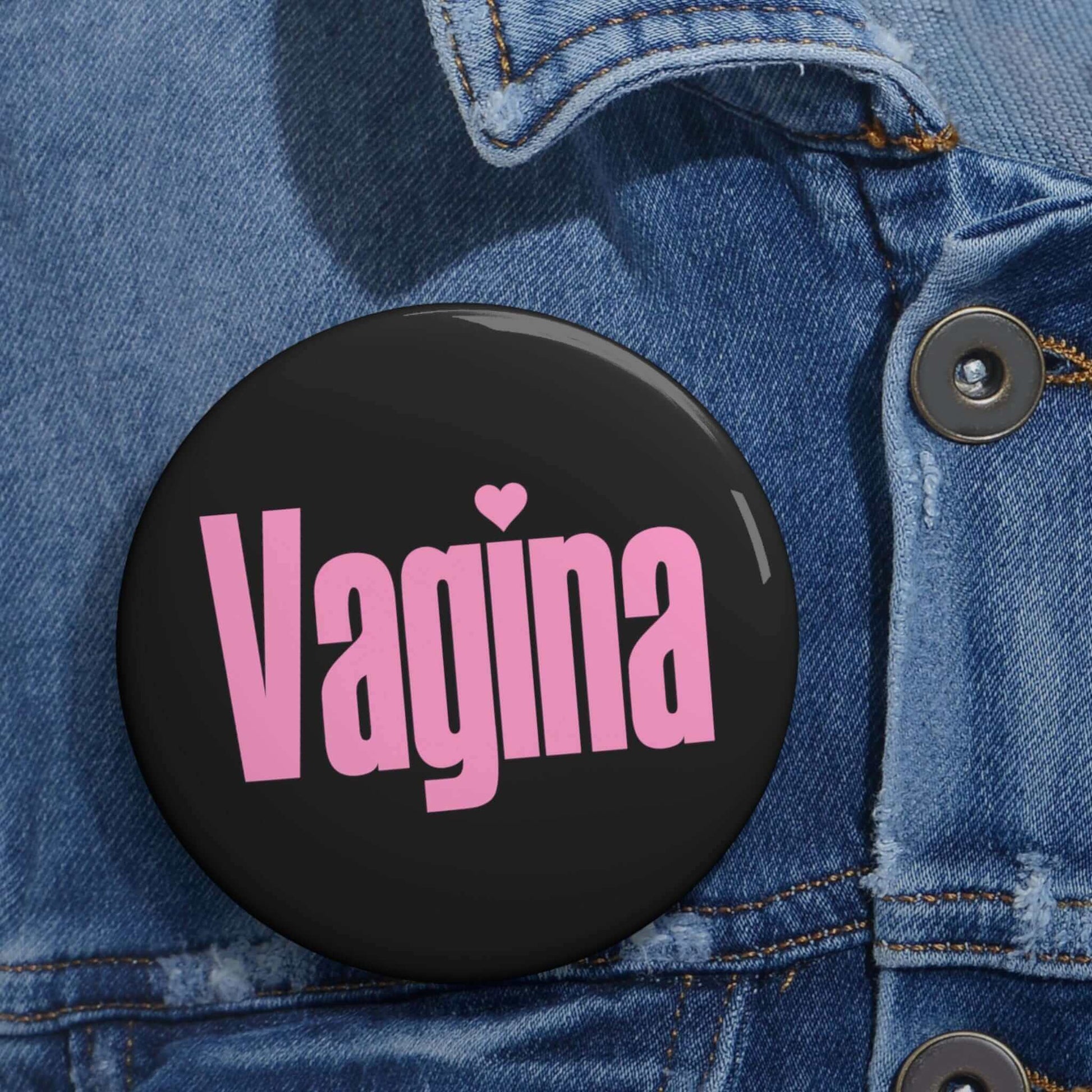 Black pinback button with the word Vagina printed in pink.