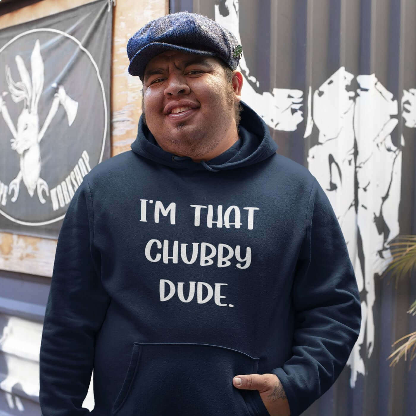 Man wearing navy blue hoodie sweatshirt with the phrase I'm that chubby dude printed on the front.