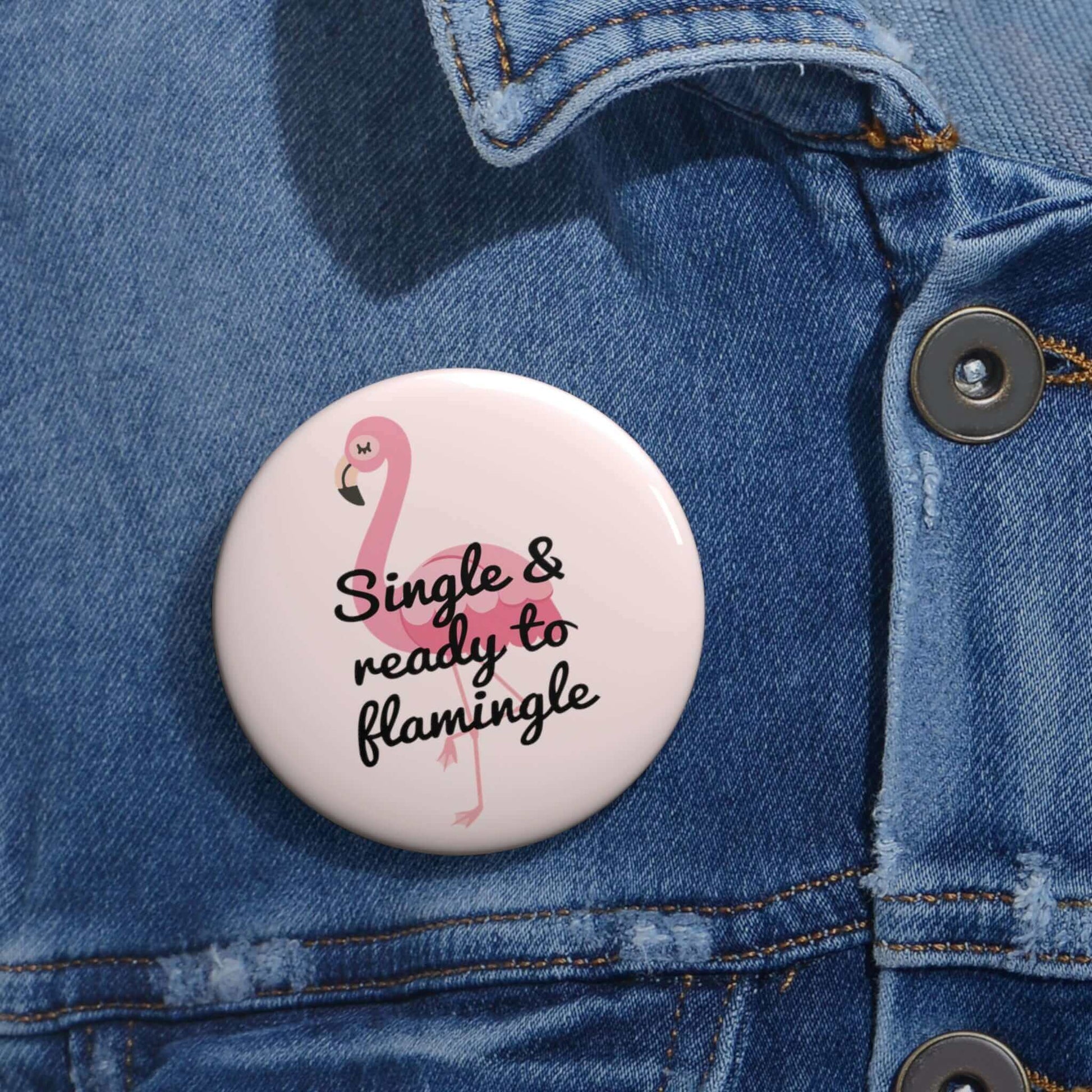 Pink pinback button with image of a flamingo and the words Single and ready to flamingle.