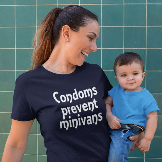 Woman wearing a navy blue t-shirt. The t-shirt has the words Condoms prevent minivans printed on the front.