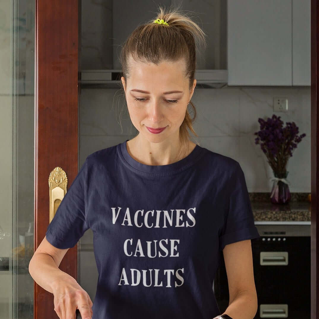 Woman wearing navy blue t-shirt with the words Vaccines cause adults printed on the front.