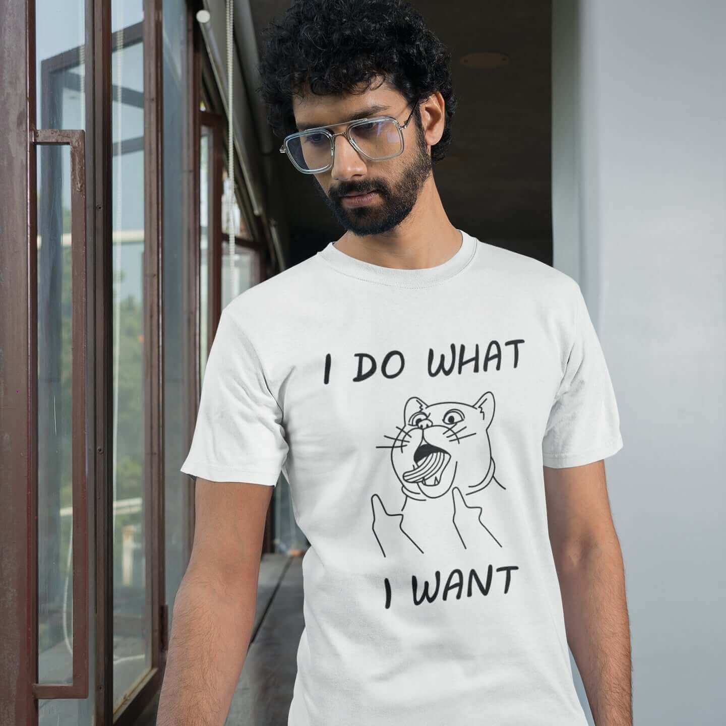 Man wearing white t-shirt with cat flipping middle fingers and the words I do what I want printed on the front.