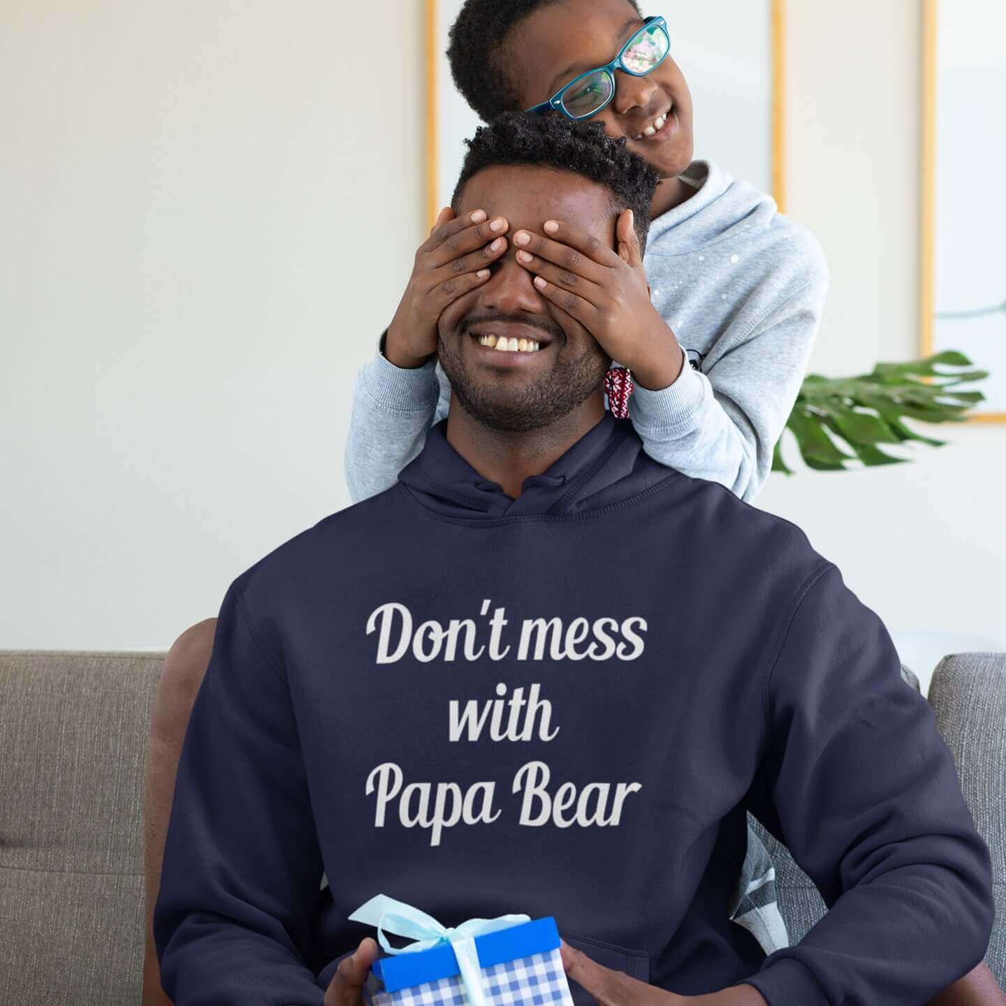 Man playing with his son wearing a Navy blue hoodie sweatshirt with the phrase Don't mess with Papa Bear printed on the front.