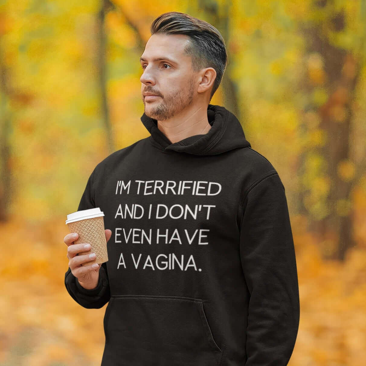 Man wearing a black hoodie sweatshirt with the words I'm terrified and I don't even have a vagina printed on the front.