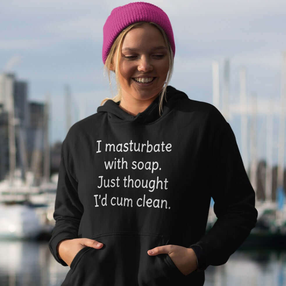 Woman wearing a black hoodie sweatshirt with the funny phrase I masturbate with soap, just thought I'd cum clean printed on the front.