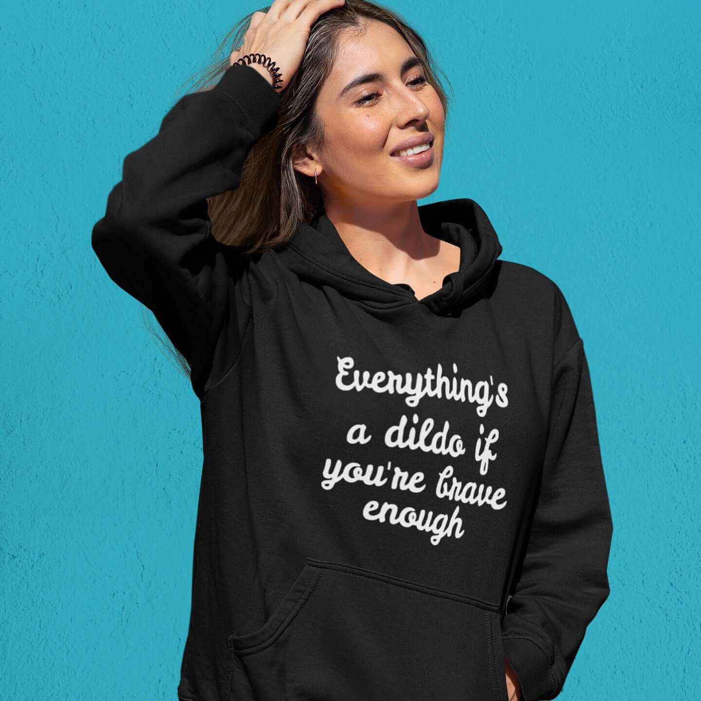 Woman wearing black hooded sweatshirt with the words Everything's a dildo if you're brave enough printed on the front.