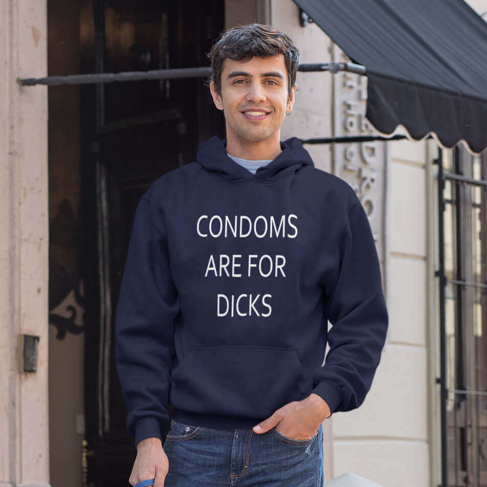 Man wearing a navy blue hoodie sweatshirt with the phrase Condoms are for dicks printed on the front.