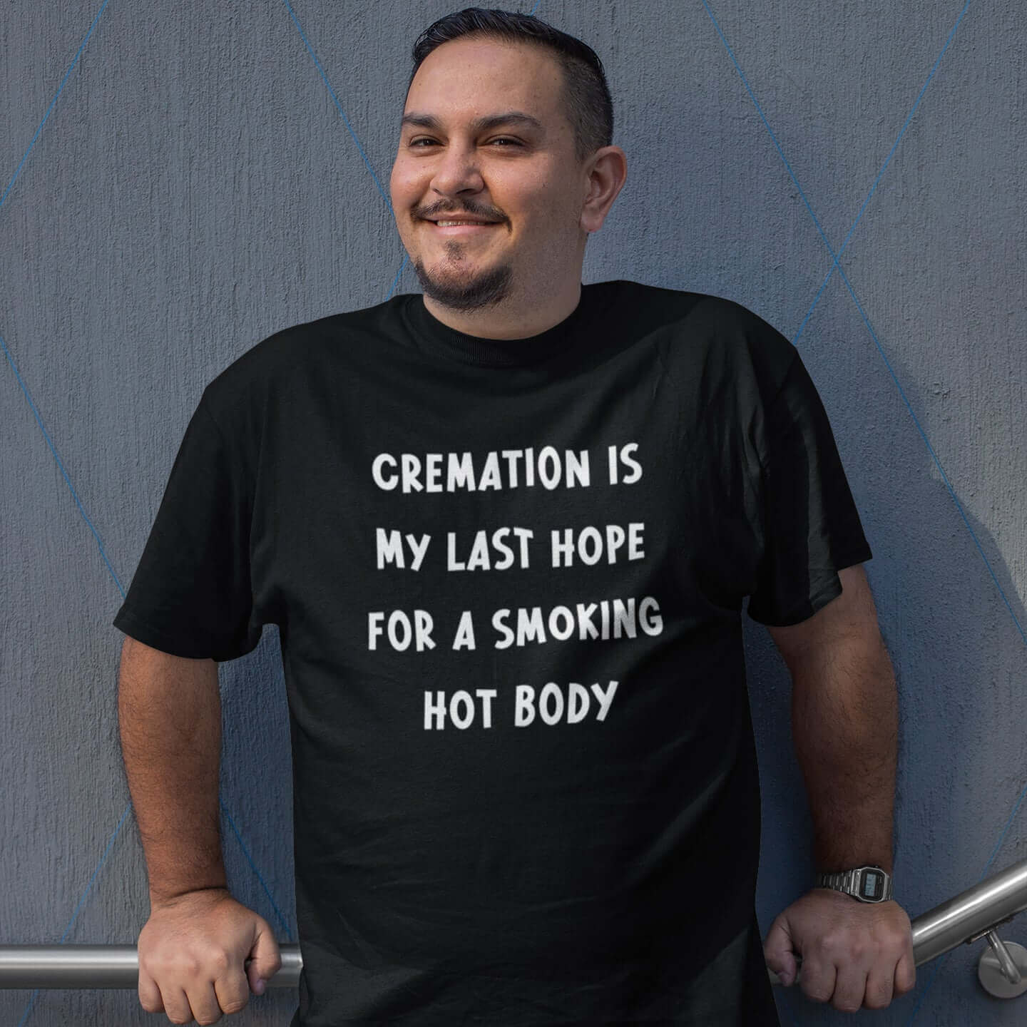 Man wearing black t-shirt with the words Cremation is my last hope for a smoking hot body printed on the front.