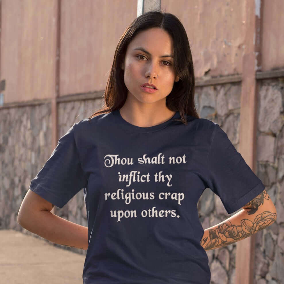 Woman wearing navy blue t-shirt with the phrase Thou shalt not inflict thy religious crap upon others printed on the front.