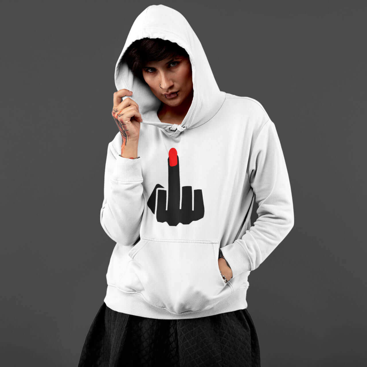 Woman wearing white hoodie sweatshirt with the hood on. The hoodie has an image of middle finger with long red fingernail silhouette printed on the front.