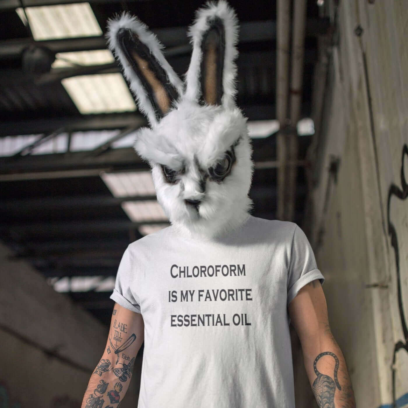 Man wearing a creepy bunny mask and a white t-shirt with the phrase Chloroform is my favorite essential oil printed on the front.