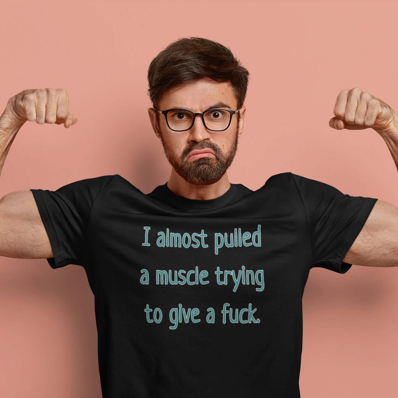 man flexing muscles wearing tshirt that says I Almost pulled a muscle trying to give a fuck by witticismsrus.com