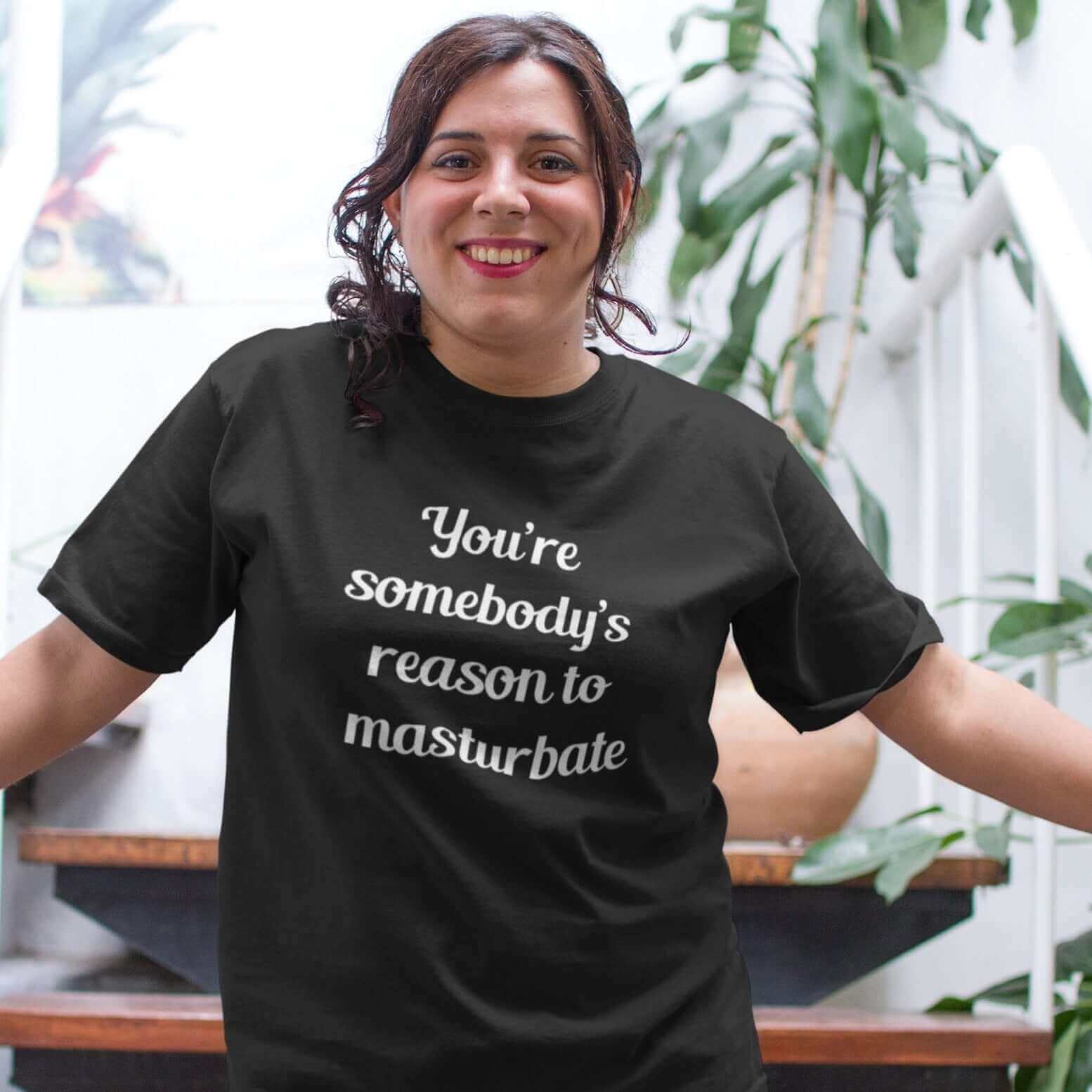 Smiling woman wearing a black t-shirt with the phrase You're somebody's reason to masturbate printed on the front.