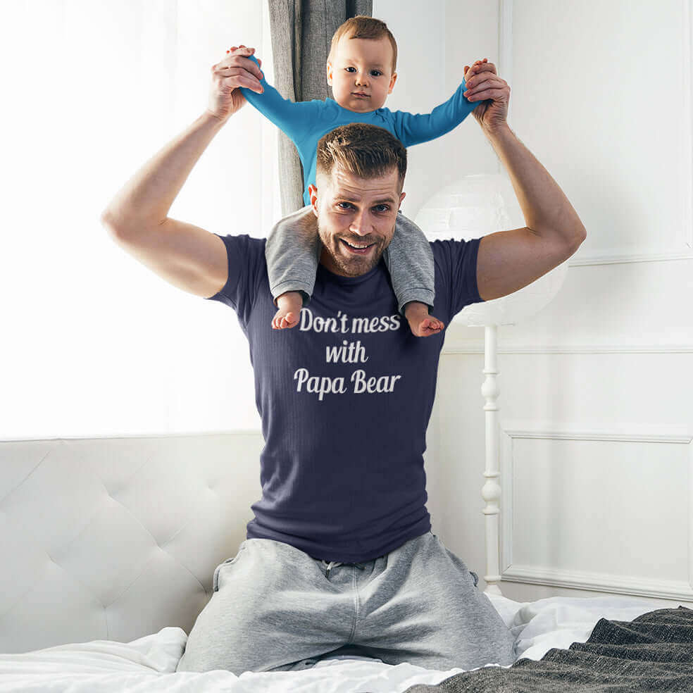 Man playing with his son while wearing a navy blue t-shirt with the phrase Don't mess with Papa Bear printed on the front.