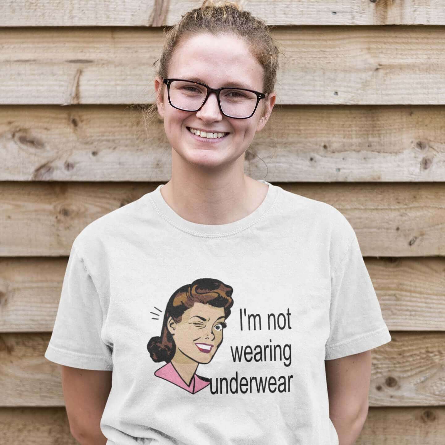 Woman wearing a white t-shirt with an image of a retro woman and the phrase I'm not wearing any underwear printed on the front.