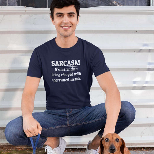 Man walking a dog wearing a navy blue t-shirt with the phrase Sarcasm, it's better than being charged with aggravated assault printed on the front of the shirt.