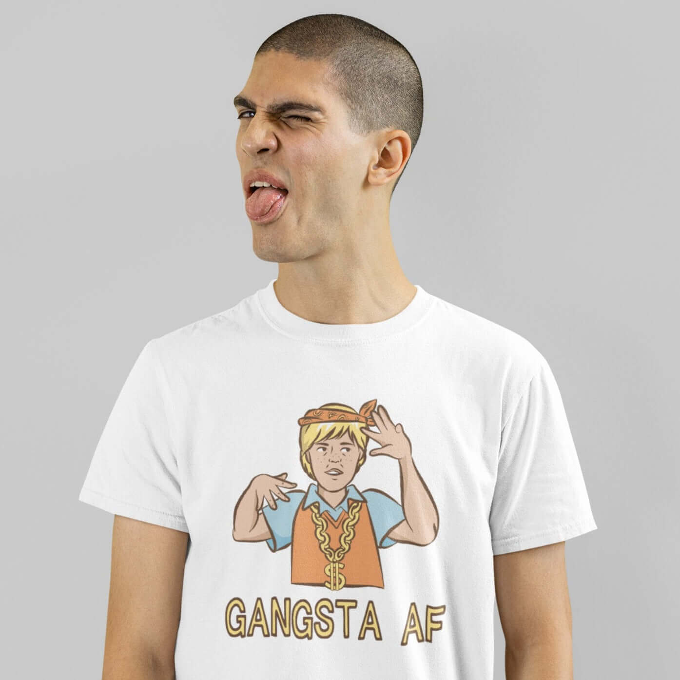 Man making funny face wearing a white t-shirt with a parody image of a blond haired child trying to be a gangster with the words Gangsta AF printed on the front.