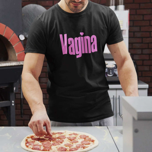 Man making pizza wearing black t-shirt with the word Vagina printed on the front. The word vagina is in pink color text.