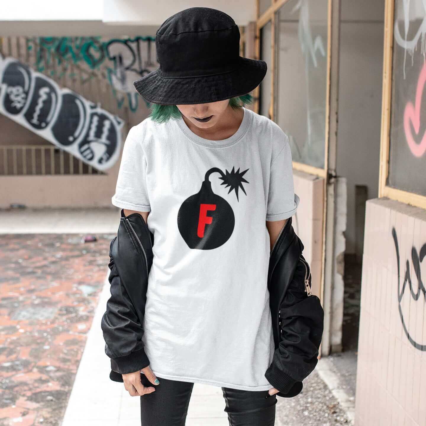 Woman wearing shite t-shirt with an image of a bomb with the letter F printed in the center. The graphics are printed on the front of the shirt.
