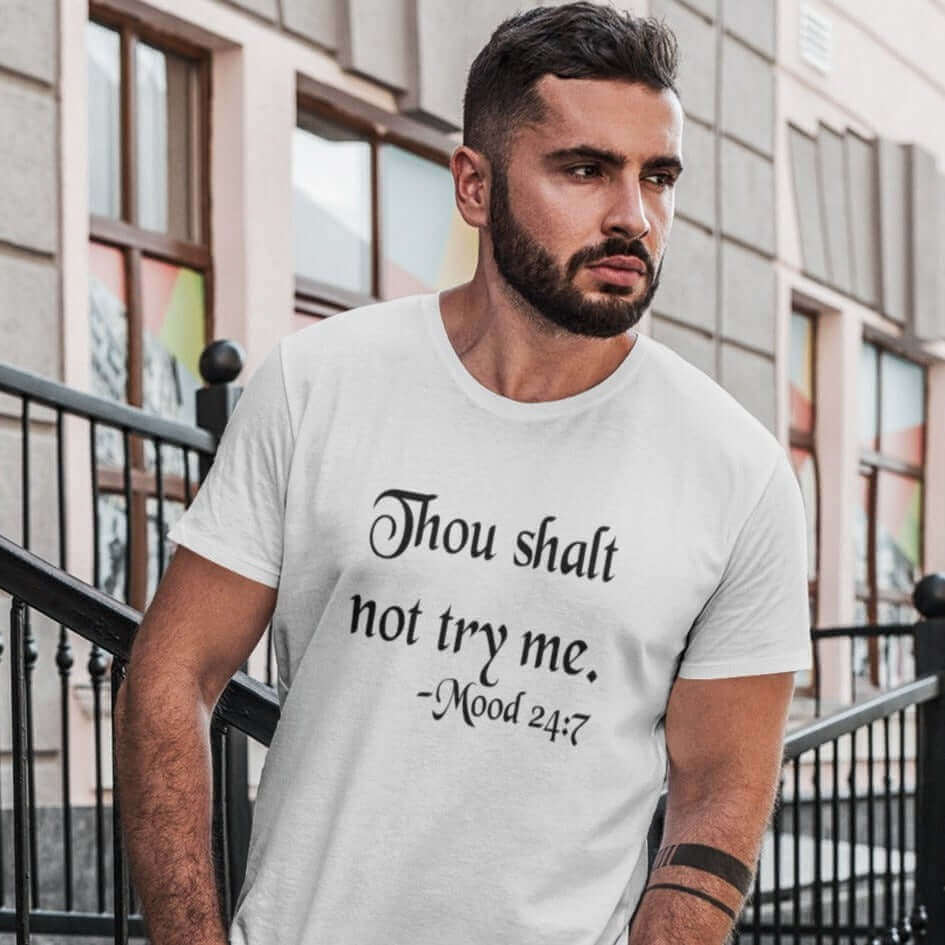 Man wearing a white t-shirt with the mock scripture quote Thou shalt not try me Mood 24:7 printed on the front.