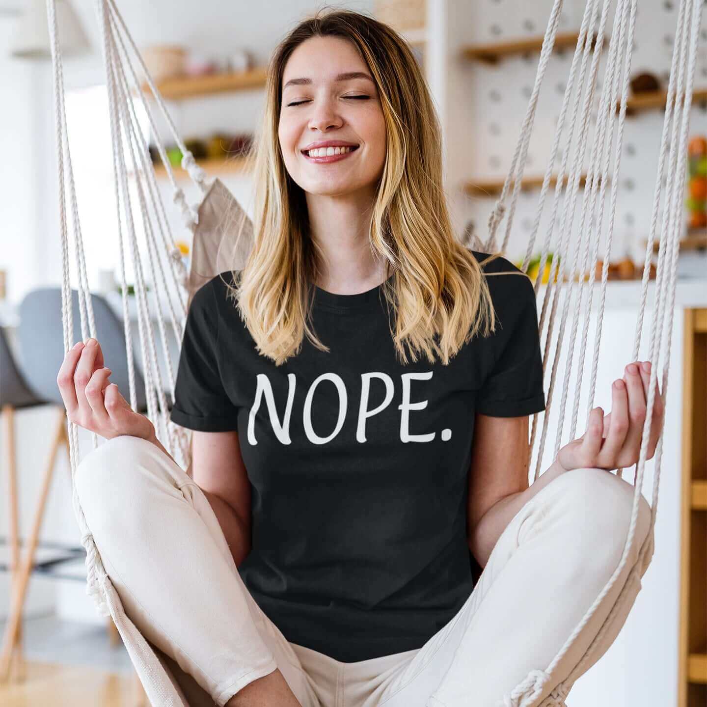 Woman wearing a black t-shirt with the word Nope printed on the front.
