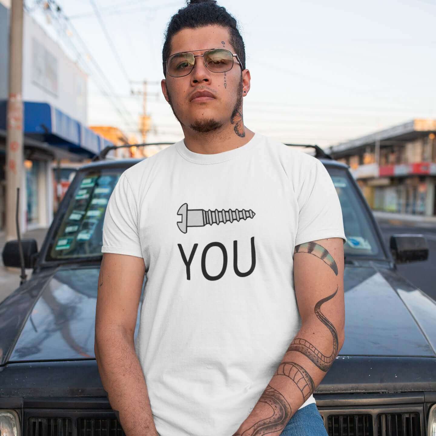 Macho looking man wearing a white t-shirt with an image of a screw and the word You printed on the front.